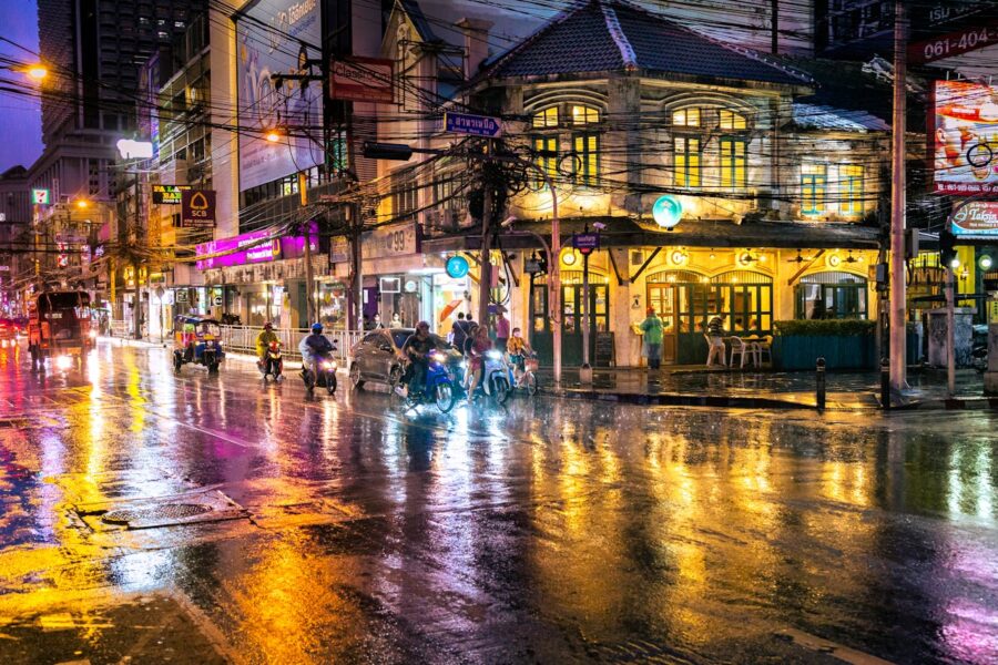 Thailand Travel Package A rainy night scene with people walking on the street